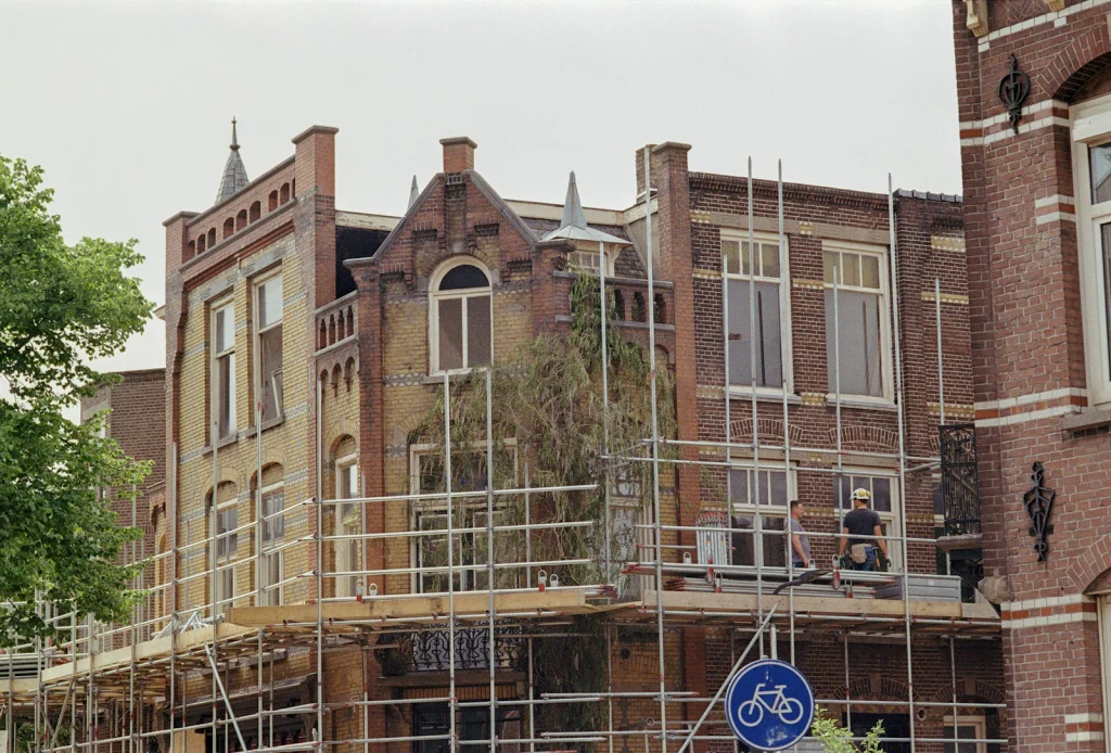 Brick building surrounded by scaffolding during construction work